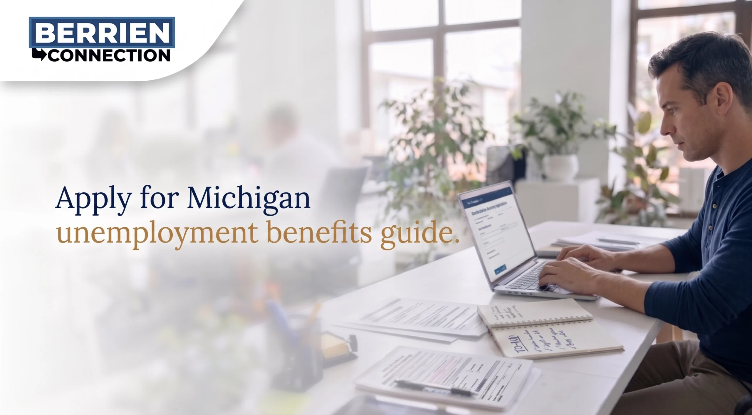 Man working on a laptop at a bright office desk with papers and notes, featuring the Berrien Connection logo and text: "Apply for Michigan unemployment benefits guide."