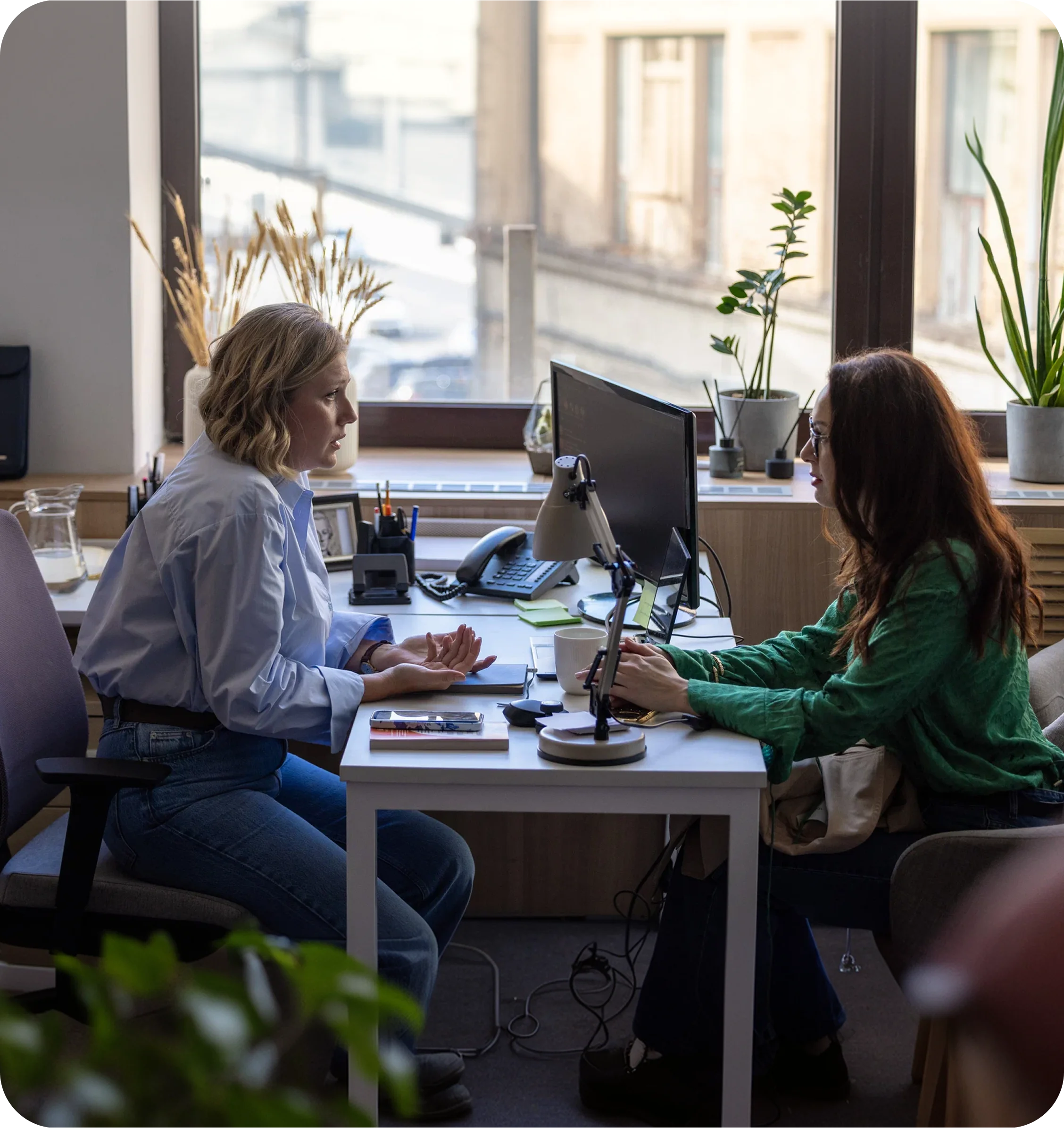 A Community Navigator talking with a resident across a desk